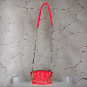 Red genuine leather crossbody with metal accents and chain on shoulder strap.